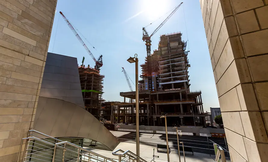 Construction site of high-rise buildings viewed through modern architecture.
