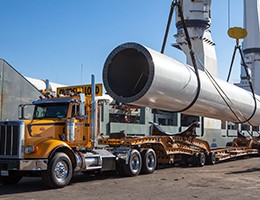 Heavy haul transport truck loading large pipe