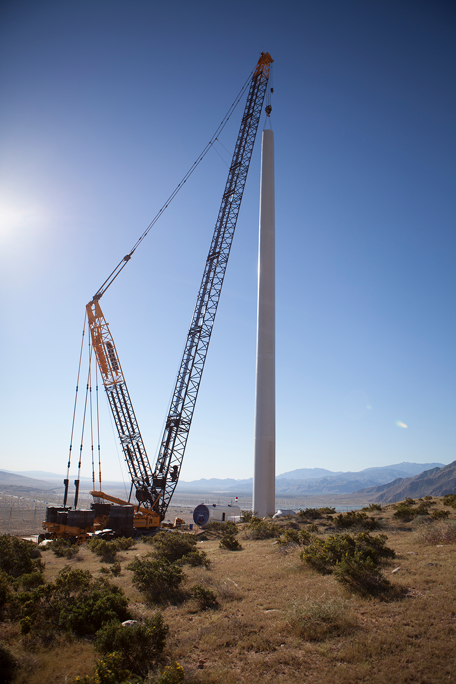 crane installing wind turbine on renewable energy project