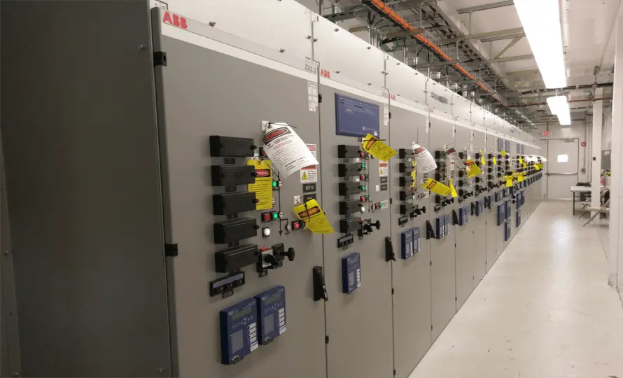 A large electrical panel filled with numerous switches and wires, showcasing complex electrical connections and controls.