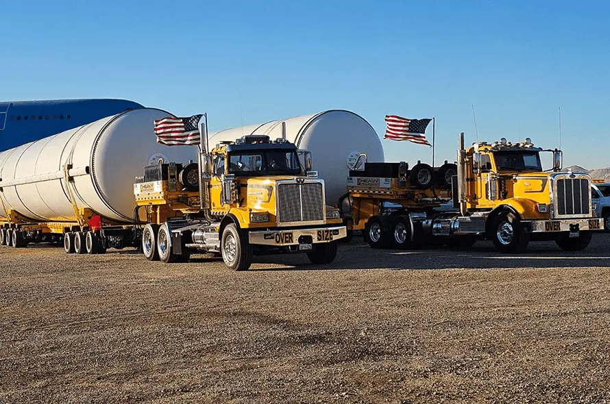 Two semi trucks with a substantial tank attached, emphasizing their role in industrial logistics and transportation.