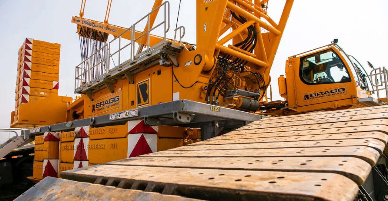 Close-up of a Bragg Crane Service crane track and counterweights.