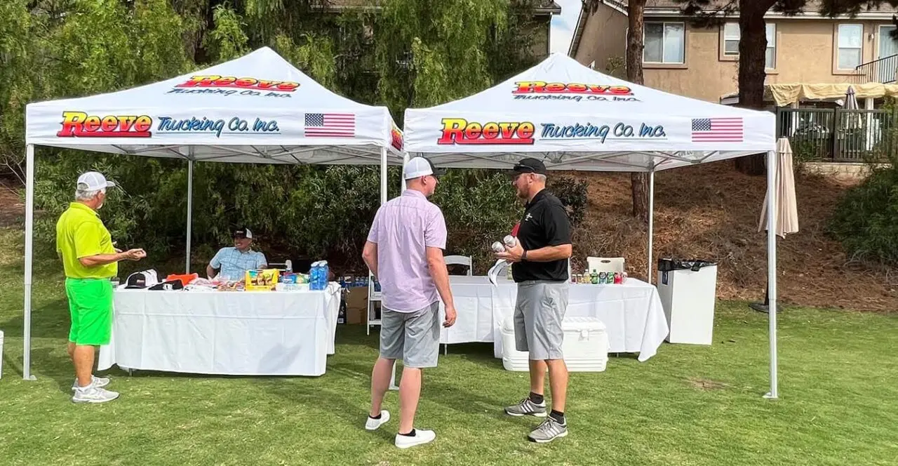 Reeve Trucking Co. Inc. booth at a golf tournament sponsorship event.