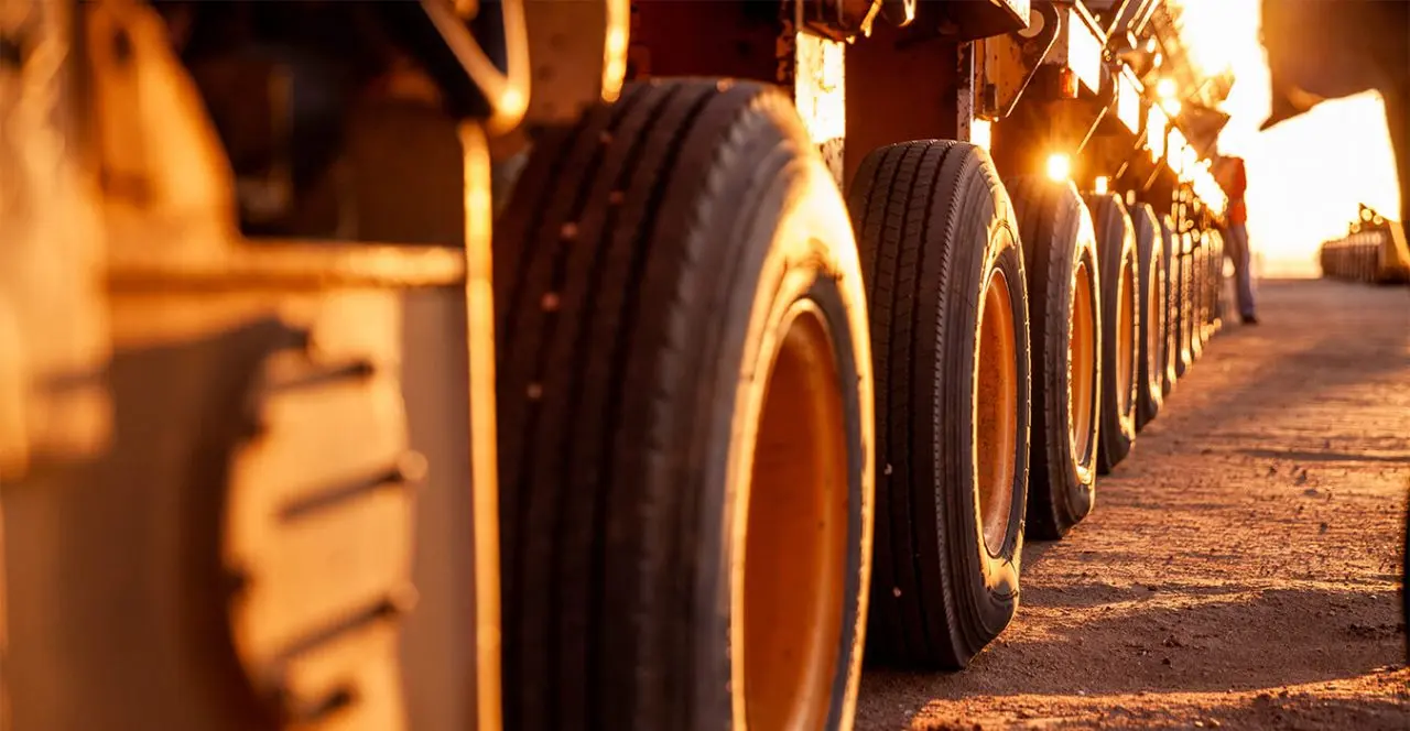Close-up of heavy-duty truck tires on a dirt road.